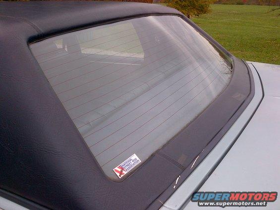 Rear window and black soft top of a car, with a National Street Rod Association sticker on the glass