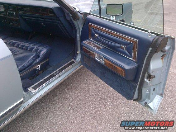 Blue interior with quilted seats and wood trim on the door panel