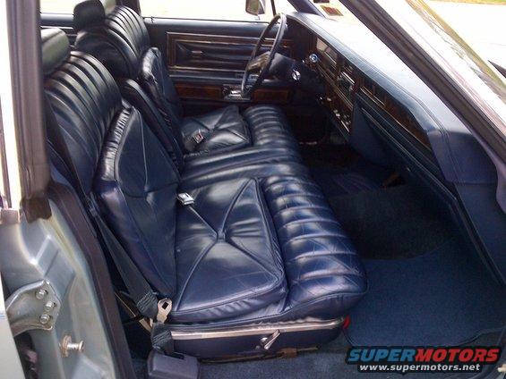Blue leather bench seats and dashboard of a car interior
