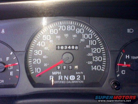 Dashboard gauges showing 163,488 miles, MPH, and RPMs