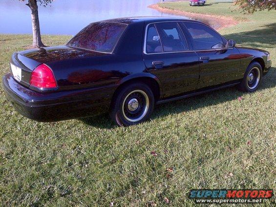 2001 Ford Crown Victoria parked on grass near a body of water
