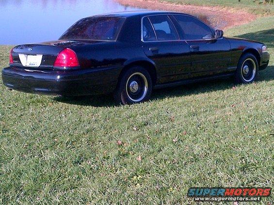 2001 Ford Crown Victoria, rear 3/4 view, parked on grass by water