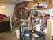 2004 Aston Martin Virage - A cluttered garage scene with various tools, storage, and a workbench.