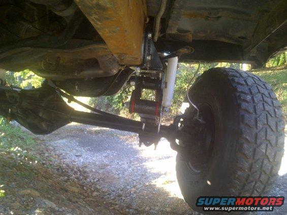 Undercarriage view of a 1995 Ford Bronco with lifted suspension and large tires
