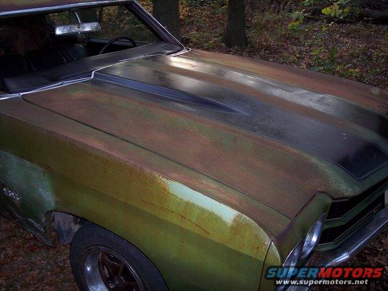Green 1970 Chevrolet Chevelle SS with rust and a black hood stripe