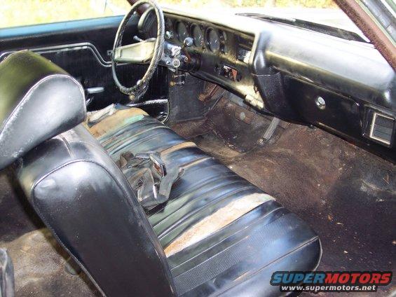 Interior of a 1970 Chevrolet Chevelle showing worn seats, dashboard, and steering wheel