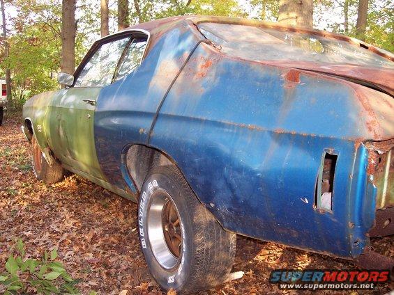 1970 Chevrolet Chevelle with rust and mismatched green and blue body panels, parked outdoors