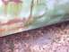 1970 Chevrolet Chevelle - Detail of a corroded car door panel, showing significant rust and paint deterioration.