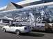 2007 Ford Mustang - White convertible Mustang parked next to a trailer Shelby Automobiles, Inc. graphics.