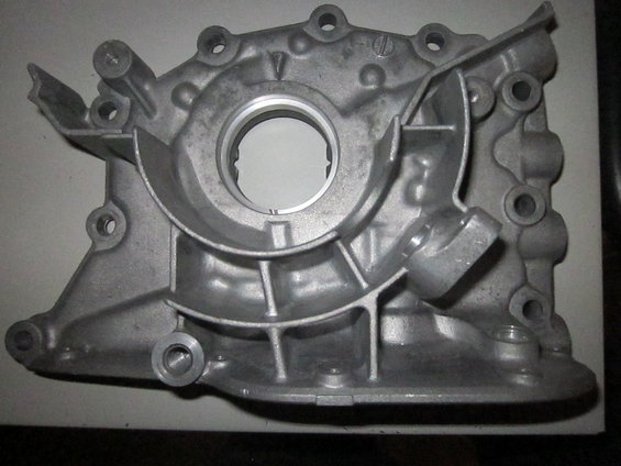 Aluminum engine oil pump housing with circular opening and mounting holes