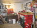 2004 Aston Martin Virage - A cluttered workshop scene with a red workbench, tools, and storage solutions.