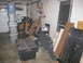 2004 Aston Martin Virage - A cluttered garage scene with various storage items and building materials is depicted.