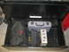 2004 Aston Martin Virage - A drawer filled with various tool bags and a toolbox, suggesting a workshop or garage setting.