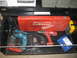 2004 Aston Martin Virage - A collection of power tools, including a red Milwaukee Sawzall case, a blue Makita drill, and a red power drill, are organized within a too…