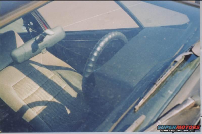 Interior view of a car showing the passenger seat, dashboard, and steering wheel