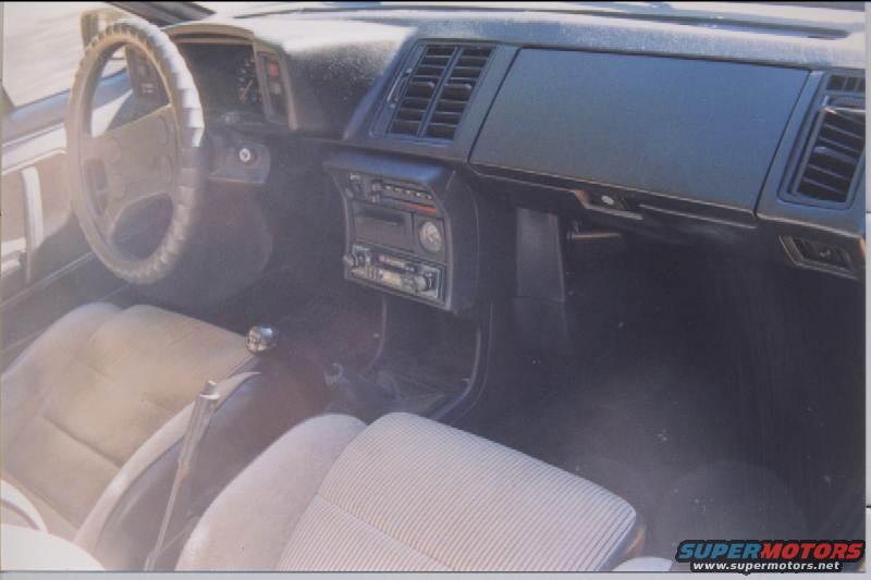 1985 Volkswagen Scirocco interior with striped cloth seats, manual transmission, and aftermarket radio