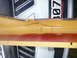 1993 Mazda MX-3 - A damaged yellow side skirt with visible cracks and red paint streaks.
