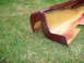 1993 Mazda MX-3 - A maroon side skirt part is shown lying on the grass.