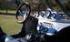 1967 Ford Mustang - The interior of a custom buggy features a roll cage, multiple gauges, and a shifter.