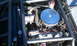 1967 Ford Mustang - Close-up view of a custom engine bay, chrome valve covers and a blue air filter assembly.