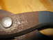 2004 Aston Martin Virage - A close-up view of a rusty metal tool, possibly shears or pliers.