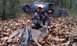 1995 Ford Bronco - A hunter poses with a deer in front of a black Ford Bronco in a wooded area.