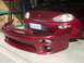 1993 Mazda MX-3 - A red 1993 Mazda MX-3 front bumper is shown detached from the vehicle.