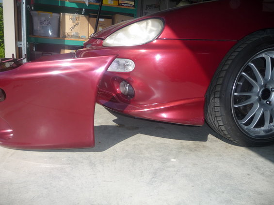 1993 Mazda MX-3 front bumper and fender, red metallic paint, aftermarket bumper cover