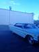 1960 Ford Falcon - A white 1963 Ford Galaxie 500 is seen from the front quarter angle, parked in front of a light-colored building.