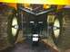 2007 Subaru Impreza - The rear hitch assembly of a yellow lawn tractor is shown, its large tires and a tow hitch.