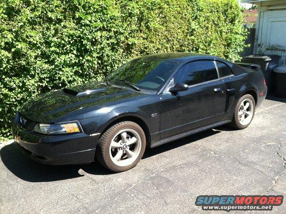 Black 2001 Ford Mustang GT coupe parked on asphalt, side view