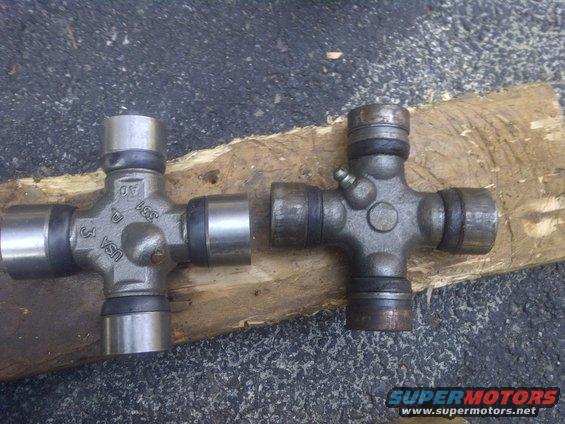 Two universal joints, one marked USA, on a wooden plank