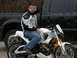2003 Buell Lightning w/Fairing - A man sits on a white Buell motorcycle parked in front of a black Ford F-Series truck.