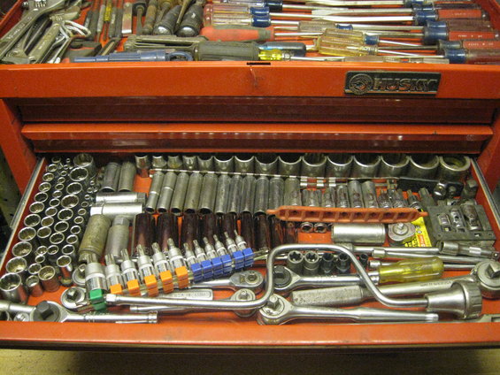 Open red Husky tool chest filled with sockets, wrenches, and screwdrivers
