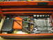 2004 Aston Martin Virage - A red toolbox drawer is open, revealing a collection of wrenches, a stethoscope, and various other tools organized within.