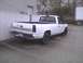 2003 Ford Crown Victoria - A white Chevrolet pickup truck is parked in an outdoor lot.