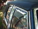 1991 Mercury Grand Marquis - Chrome trim accents the windows and black vinyl top of a car.