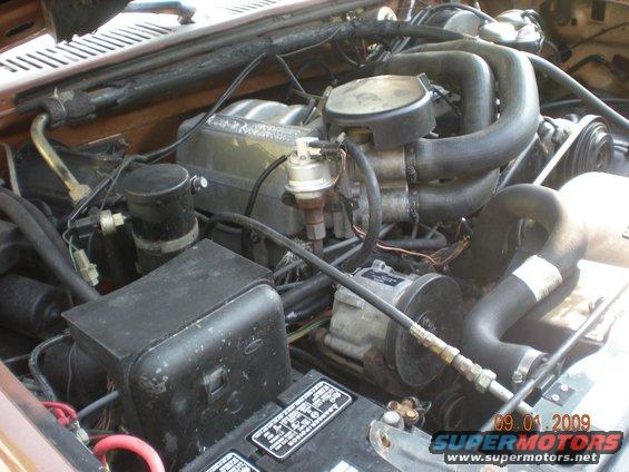 Engine bay with hoses, belts, and engine components visible. Date stamp reads 09.01.2009