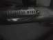 2003 Ford Crown Victoria - Close-up of a stainless steel exhaust pipe a circular emblem with 'STAINLESS WORKS' text.
