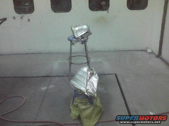Car fender being prepped for paint in a booth