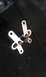 1991 Ford Festiva - A close-up view of a metal linkage component, likely a car part, against a dark background.