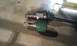 1991 Ford Festiva - Comparison of two CV axles, one with a green boot and one with a black boot.