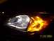 2003 Ford Taurus - Close-up of the front headlight and amber turn signal assembly on a 2003 Ford Taurus.