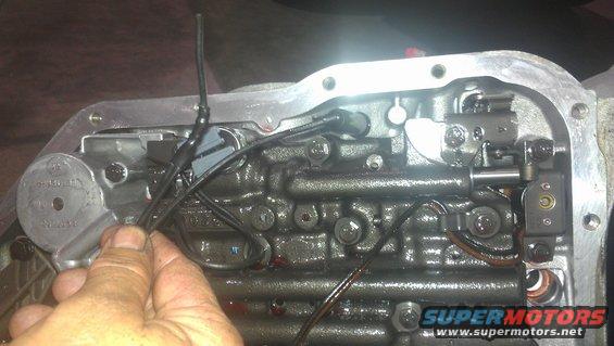 Automatic transmission valve body with wires being held by a hand