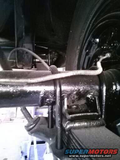 Rear axle and leaf spring assembly with brake line