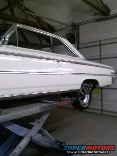 White 1963 Ford Galaxie on a lift, side view