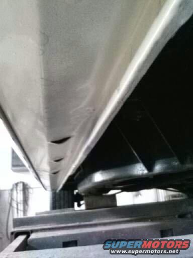 Underside view of a car's rocker panel and frame