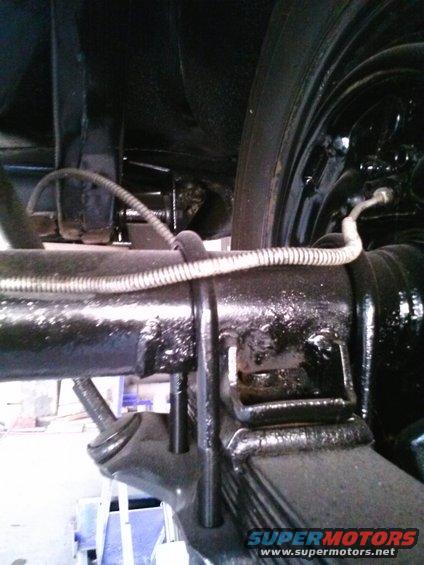 Blackened rear axle assembly with leaf springs and brake line