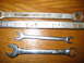 2004 Aston Martin Virage - A collection of four wrenches, some with size markings and USA origin, laid out on a wooden table.