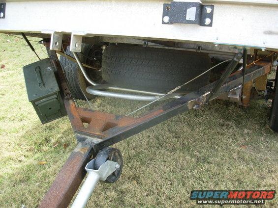 68struts.jpg I finally found some junkyard lift struts that would fit & work to hold the deck tilted, and installed them.  To keep them from hanging too low, I had to use 3.  But they don't interfere with accessing the spare tray.

The little angle iron at the split transfers some of the pulling load directly from the tongue tube to the deck frame.
